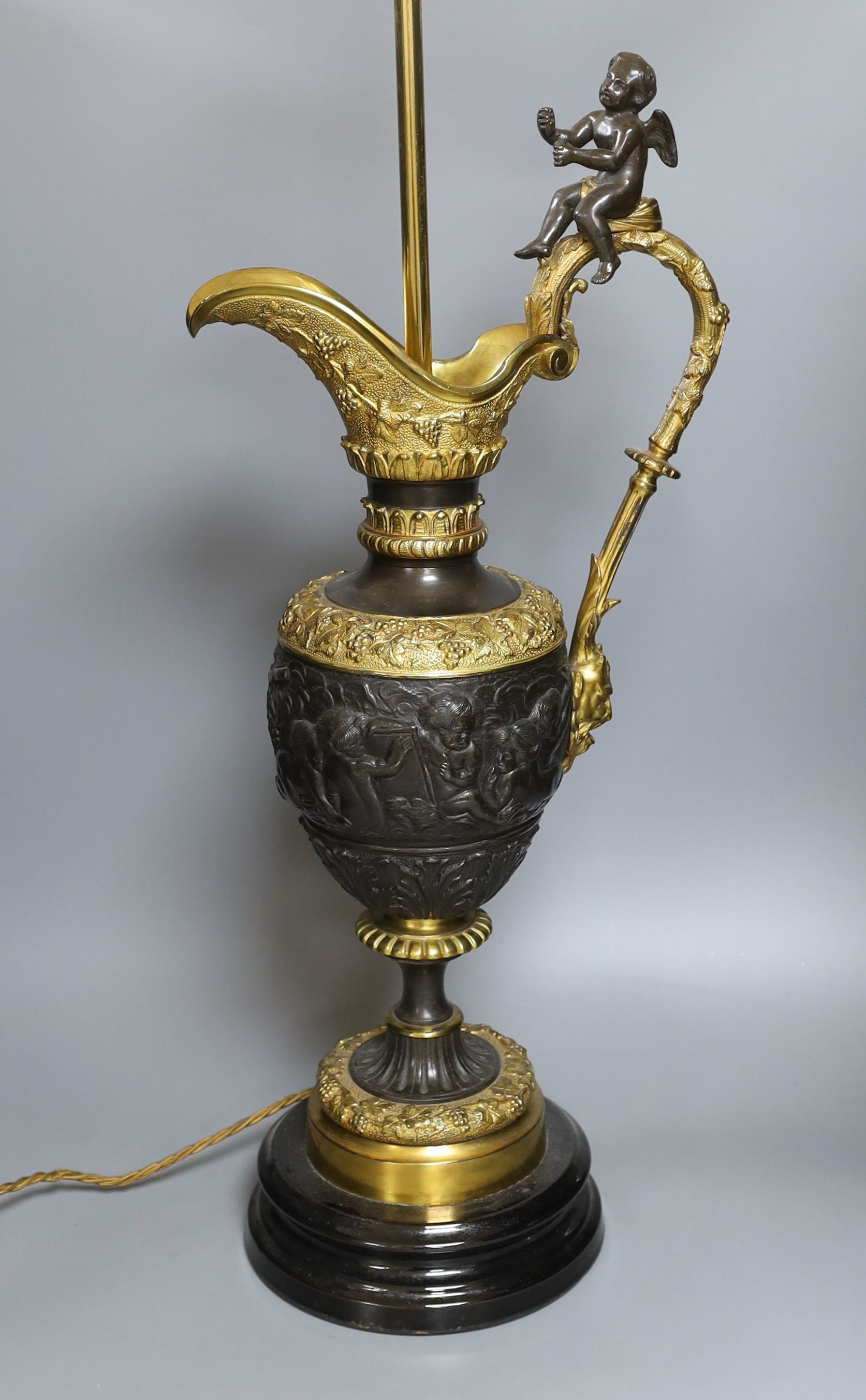 A large decorative bronze 'ewer' lamp with seated cherub - 75.5cm tall